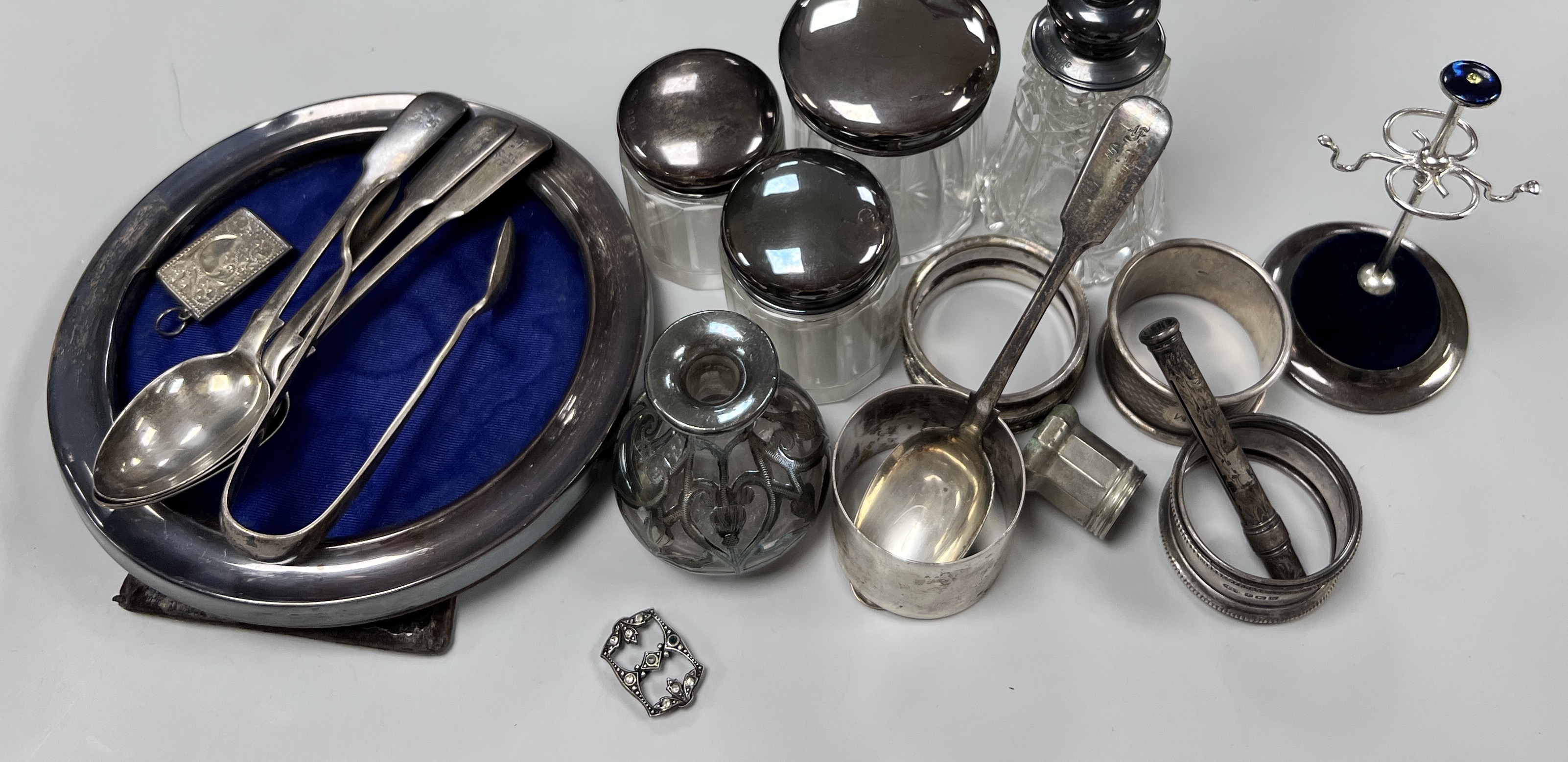 Sundry small silver including circular photograph frame, toilet jars, napkin ring ring tree etc.